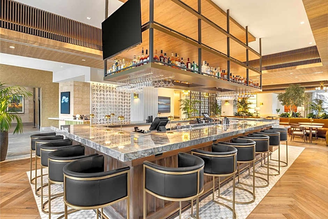 The Moran lobby bar with a horseshoe counter and warm architectural materials